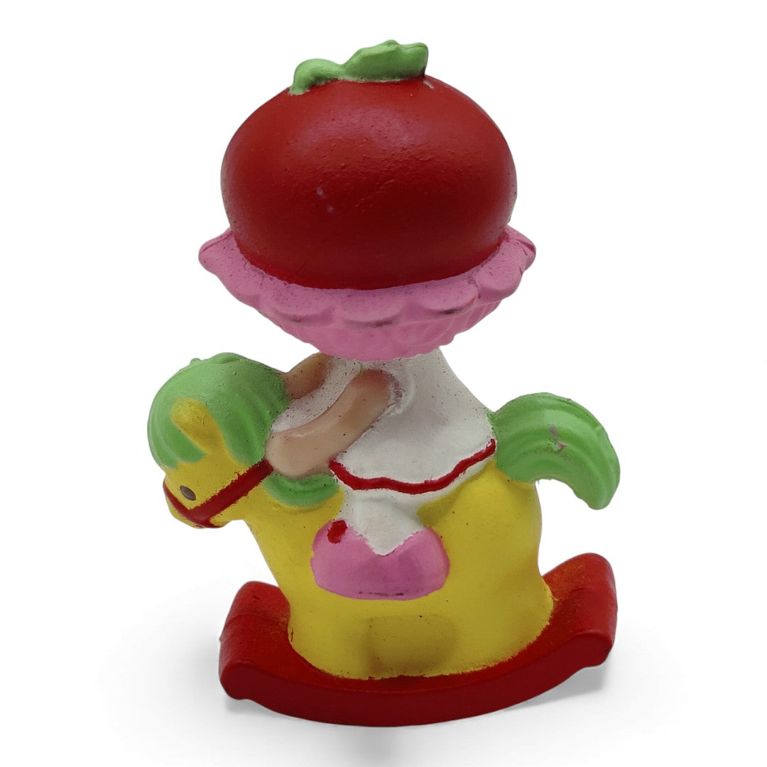 Vintage 1980s mini pvc figure. Strawberryland Miniatures. Cherry Cuddler. On Rocking Horse 2". Back view.