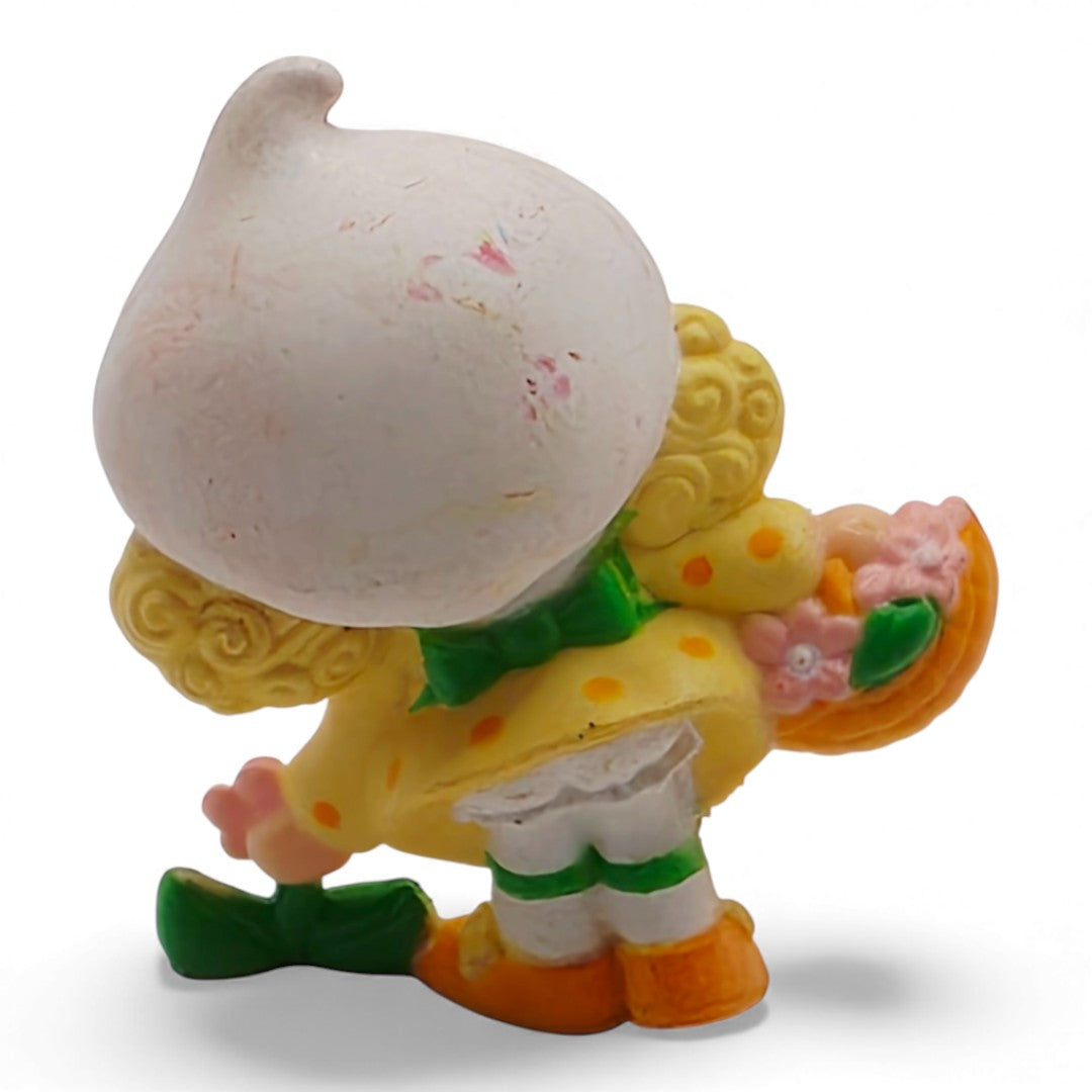 Vintage 1980s mini pvc figure. Strawberryland Miniatures. Lemon Meringue. Picking Flowers 2". Back view.