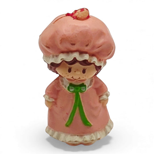Vintage 1980s mini pvc figure. Strawberryland Miniatures. Strawberry Shortcake. In Nightgown 2". Front view.