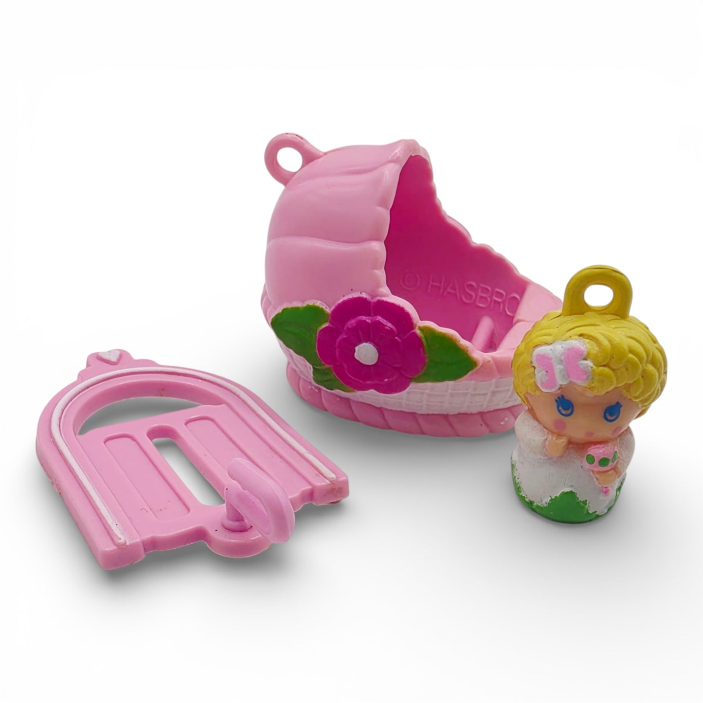 Vintage 1980s small toy. Second Release. Baby Sunshine. Complete with Original Bassinette & Pocket Clip. Front view.