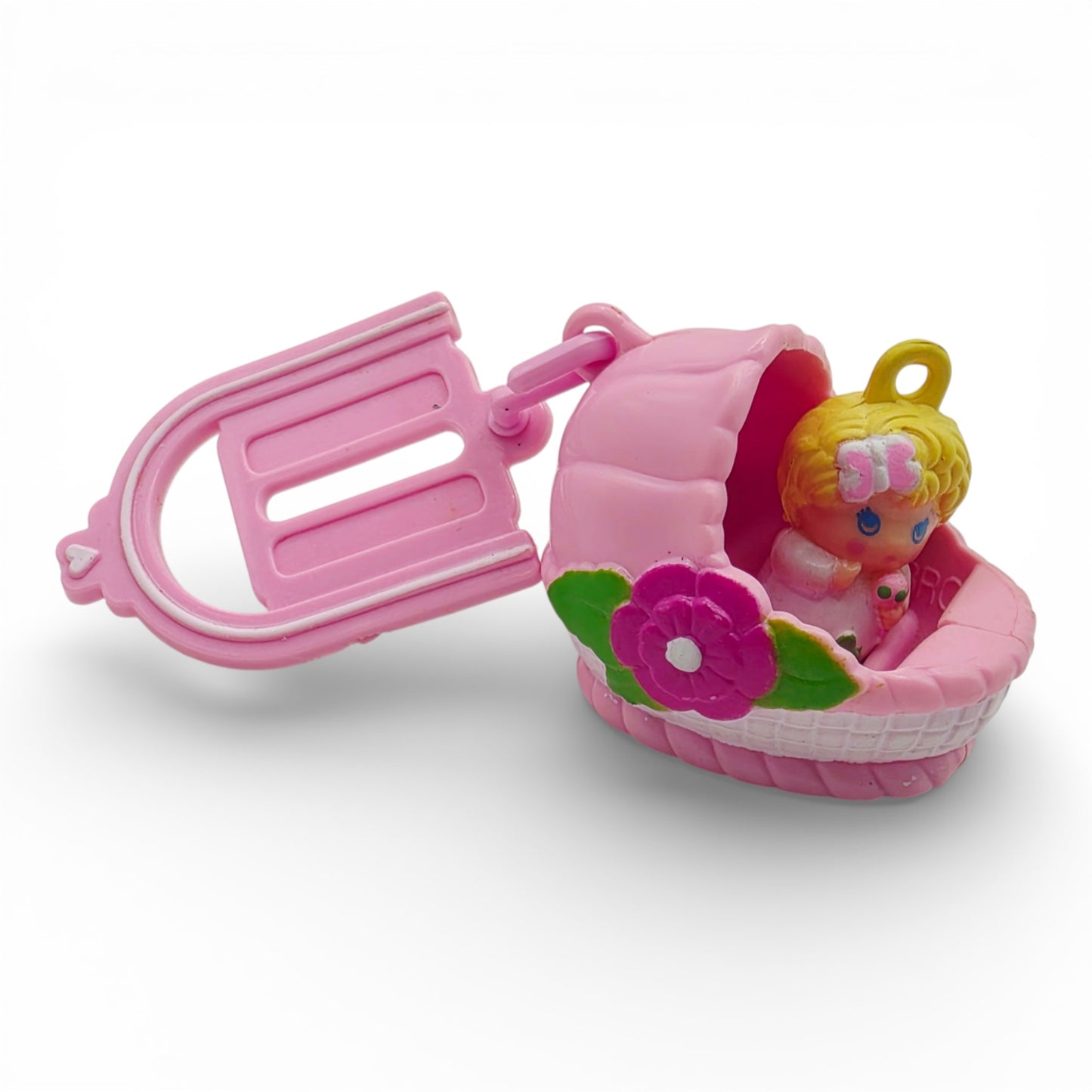 Vintage 1980s small toy. Second Release. Baby Sunshine. Complete with Original Bassinette & Pocket Clip. Left view.
