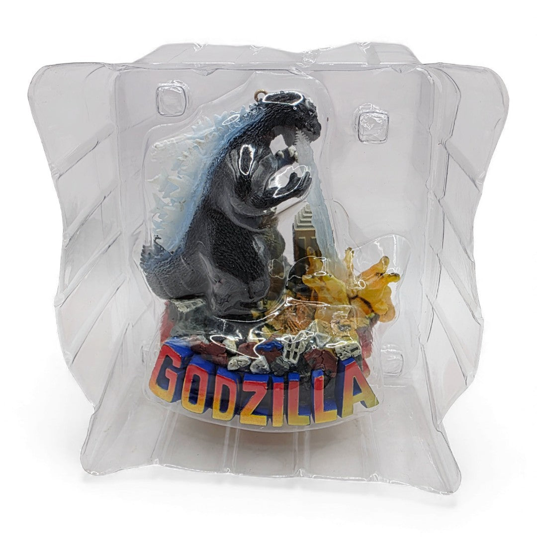 Vintage 2000s action figure accessory. Heirloom Ornament Collection. Godzilla is Coming to Town! Light up Ornament. Face view.